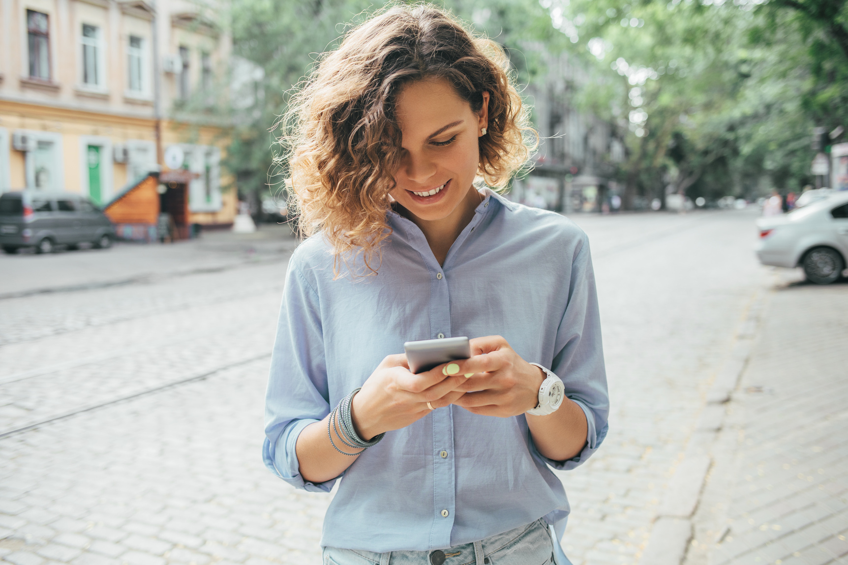 Happy Young Woman Wearing Blue Shirt Using Mobile Phone